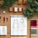 Icon showing custom clothing design studio workspace with sketches